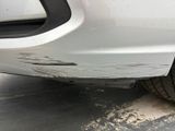 a close up of a car ' s front bumper with a lot of dirt on it