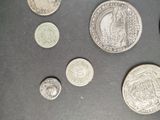some coins are sitting on a table with a black background