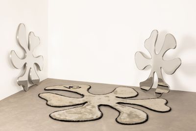 two mirrors sitting on the floor next to each other