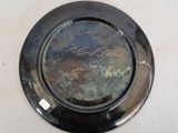 a metal plate with writing on it sitting on a table