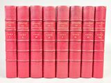 six livres roses alignés les uns à côté des autres sur une surface blanche