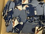 many pairs of socks in a box with tags on them