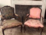 two chairs sitting next to each other in front of a fireplace