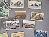 a display of old photographs and postcards on the wall