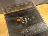 a small radio sitting on top of a wooden table