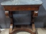 a marble top table with a mirror above it