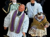 three figurines of men dressed in medieval clothing