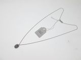 a close up of a necklace with a tag attached to it