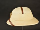 the hat is tan and has a brown band around the brim