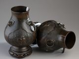 two vases sitting next to each other on a table
