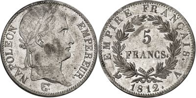 a silver coin with a woman ' s head and laurels on it