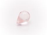 a close up of a pink quartz stone on a white surface