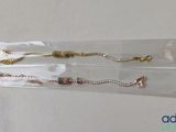 three bracelets that are in a clear bag