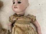 two dolls laying next to each other on the floor