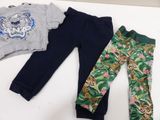 three pieces of clothing are laid out on a white surface