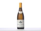 a bottle of white wine sitting on top of a table