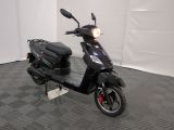 a scooter parked in a room with a checkered floor
