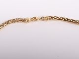 a gold chain bracelet on a white background