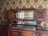 a large wooden cabinet with a mirror on top of it