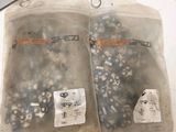 two bags of screws and nuts on the table