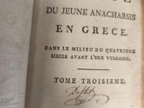 an old book with writing on it sitting on a table