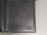 wallet sitting on a table next to a cell phone on top of a table