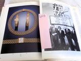 an open book with a picture of a group of men in suits and ties