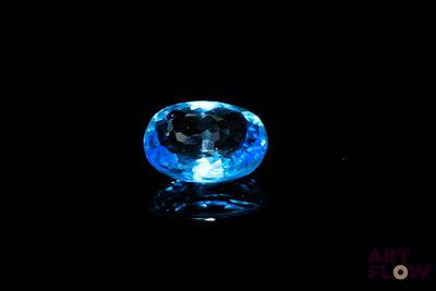 gros plan d'un diamant bleu sur une surface noire