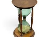 an hourglass with a wooden base on a white background