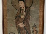 painting on the wall of a room with a painting of a woman and a bird