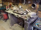 a workbench in a garage with many tools on it