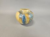 a small vase with a blue and yellow design on it