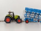 three toy tractors that are lined up in a row