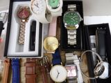 many different watches in a box on a table