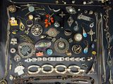 many different types of necklaces and bracelets laid out on a table
