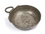 an old frying pan with a handle on a white surface