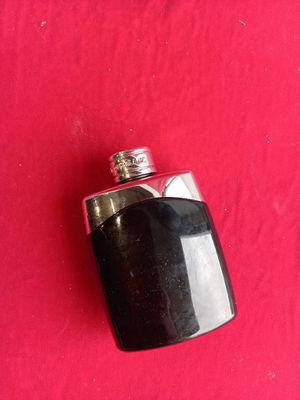 a black flask with a silver top on a red background