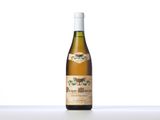 a bottle of white wine sitting on top of a table