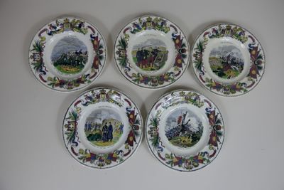 four plates with different designs on them on a white surface