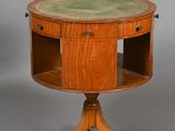 a small table with a green top and a wooden base