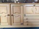 a wooden cabinet with doors and drawers on it