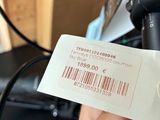 a person holding a barcode that is attached to a bike