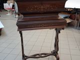 a piano that is sitting on a table in a room