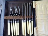 six knives in a case with a knife holder