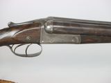 an old gun with a wooden handle on display in a museum