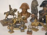 a lot of bronze figurines that are on a table