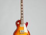 an electric guitar hanging on a wall with a white background