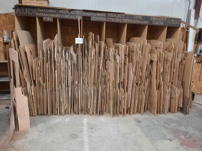 a lot of cardboards stacked on top of each other in a warehouse