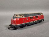 a red and black train on a gray surface