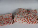two pieces of cloth with orange coral print on them